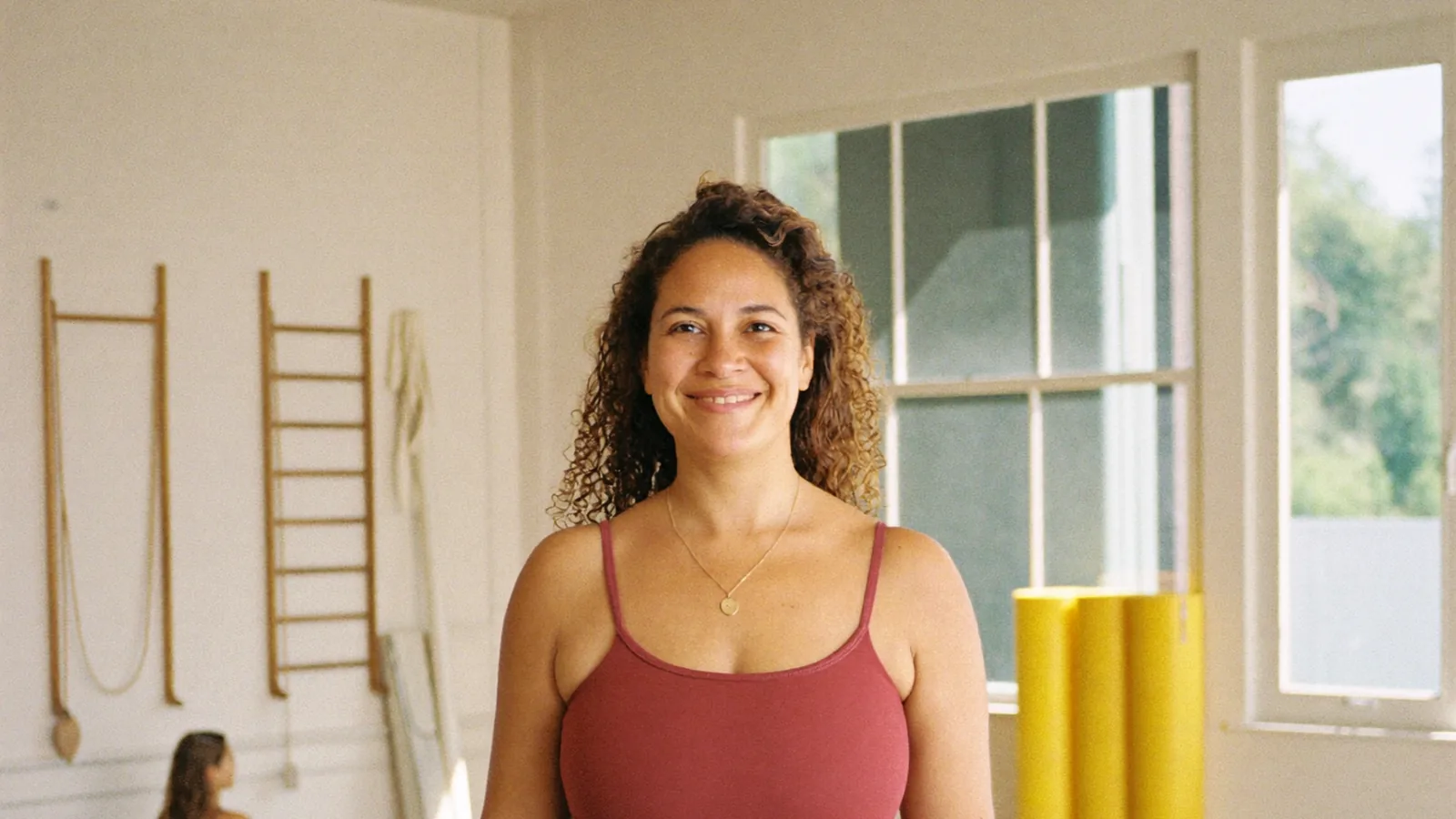 A yoga studio owner standing in her studio